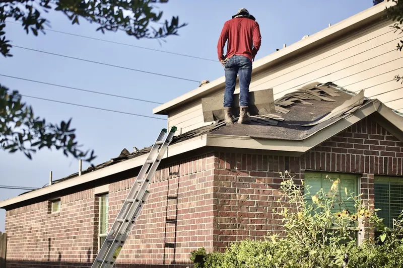Professional roofer working on a residential roof in Beetree Manor